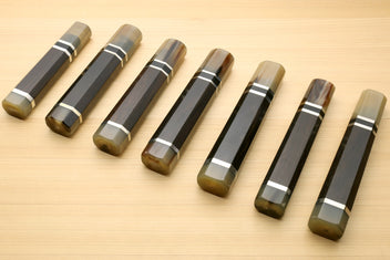 Chef knife handles arranged diagonally, horn bolster ends and triple ring stripe bands, for Kiritsuke knives