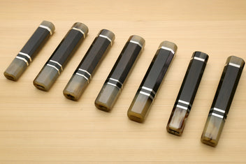 Chef knife handle set showing multiple sizes, horn bolster ends and triple ring stripes, for Kiritsuke knives