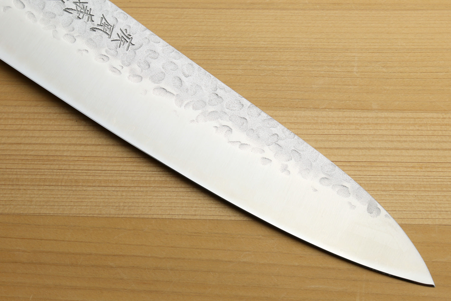 knife blade on a wooden surface