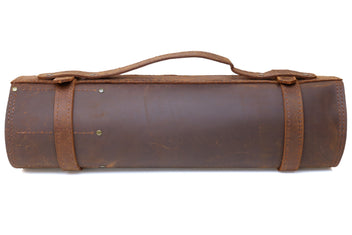 Brown leather knife storage roll with carry handle and side closure straps