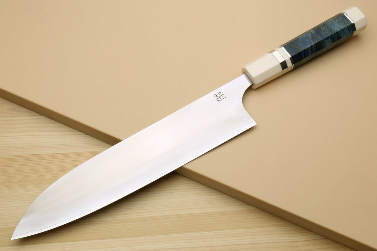 Gyuto chef's knife with polished blade, blue handle, and ivory bolsters