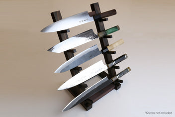 Ebony and rosewood knife rack stand with slots holding multiple kitchen knives