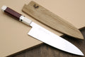 A Japanese-style chef's knife with a polished silver blade and a reddish-brown wooden handle, shown alongside its matching light wood sheath on a beige background.