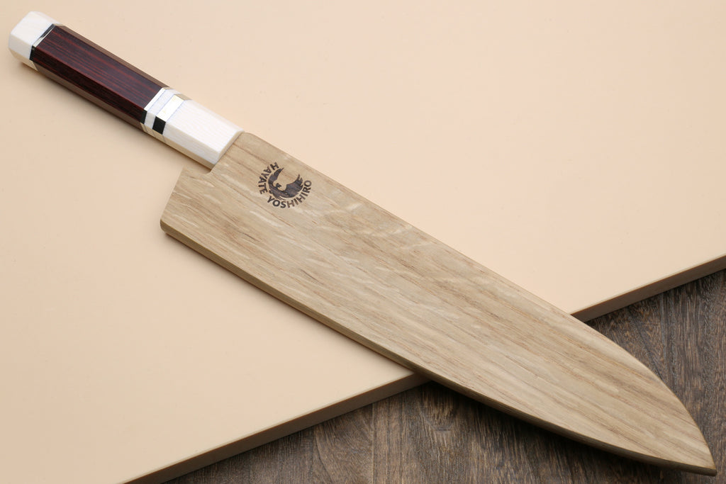 A Japanese-style chef's knife with a light wood-grain blade and a dark reddish-brown wooden handle, resting diagonally on a beige background.