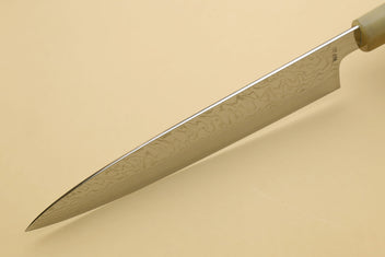Damascus gyuto chef knife blade side view with wavy Damascus pattern