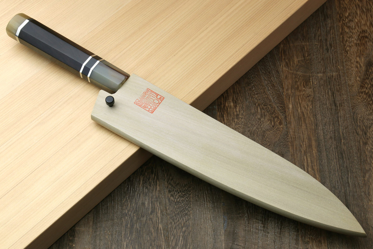 Gyuto chef knife angled view showing ebony handle and long stainless blade