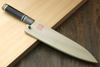 Gyuto chef knife angled view showing ebony handle and long stainless blade
