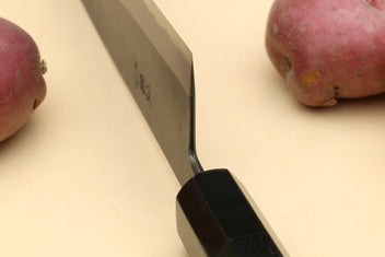 Japanese gyuto knife close-up of spine and ebony handle