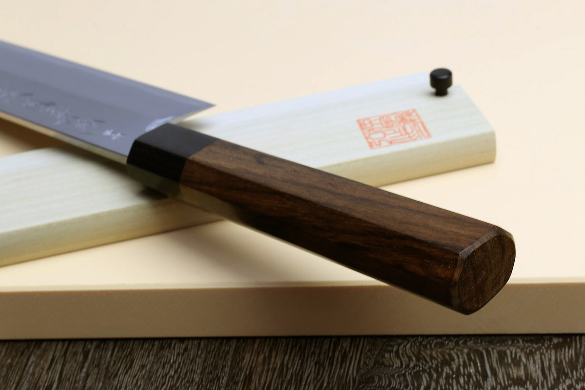 Japanese vegetable cleaver knife, blue steel blade with rosewood handle on light saya