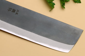 Nakiri knife blade close-up showing etched characters on gray steel