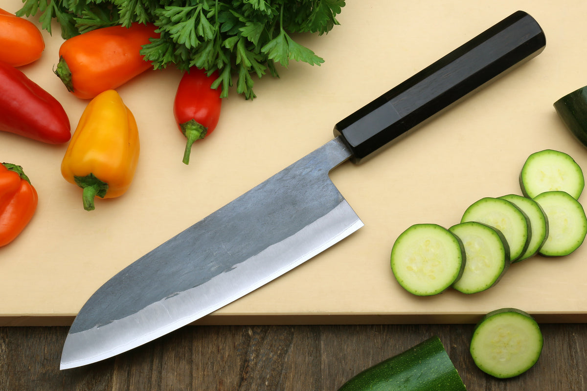 Santoku-style knife with black handle and stainless blade