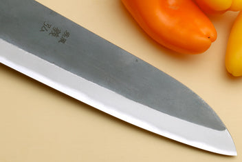 Santoku knife tip close-up with stainless blade and sharp edge