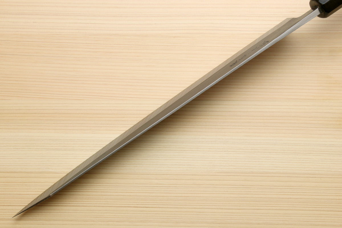 Sujihiki slicer knife in profile with long silver blade and dark ebony handle.