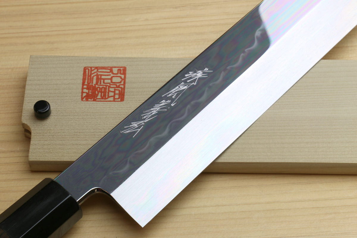 Japanese vegetable knife close-up: white mirror-polished blade with engraved text