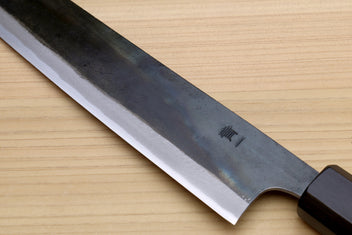 Japanese utility kiritsuke knife close-up of curved blade and blade edge, dark handle