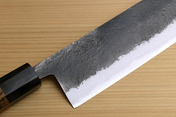 Japanese nakiri knife blade close-up with dark collar and silver edge