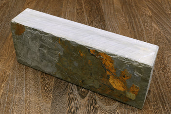 Natural sharpening whetstone, speckled gray block with orange-brown streak