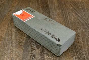 Natural whetstone finishing stone, grey rectangular bar with orange label on top