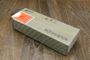 Natural sharpening whetstone in gray wrap, printed label on top