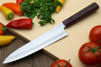 Damascus chef knife with hammered blade texture and dark handle