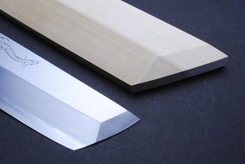 Japanese eel bone slicer knife, close-up of polished blade edges and engraving.