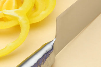 Santoku chef's knife heel and blade transition with hammered steel and silver edge