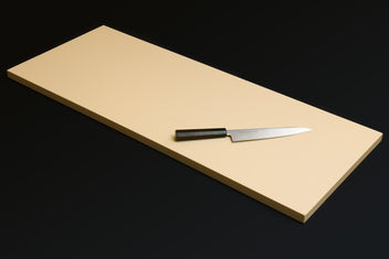Cream Japanese cutting board with chef knife and black handle on top.