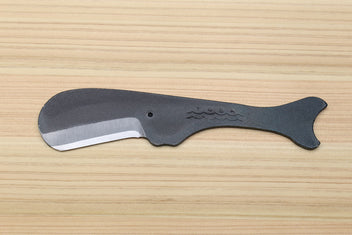 Utility knife with dark kurouchi finish, whale pattern, and curved silver blade