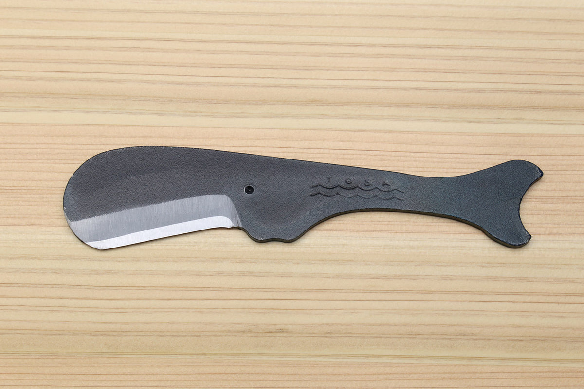 Utility knife side view with silver blade and dark kurouchi whale-shaped handle