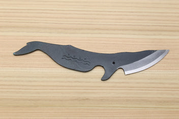 Whale-shaped Japanese utility knife with wavy handle pattern and dark kurouchi blade