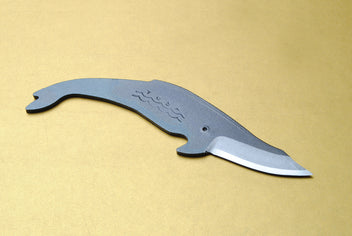 Whale-shaped utility knife with dark kurouchi handle and silver cutting edge