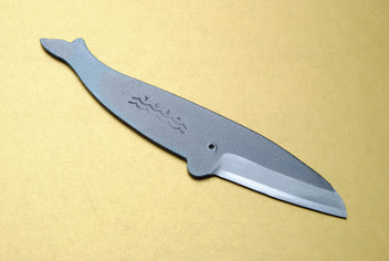 Japanese utility knife with dark kurouchi finish, wave engraving, and pointed blade