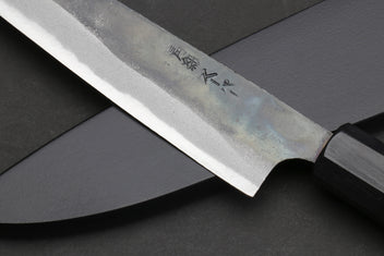 Petty utility knife blade with engraved text on darkened steel, dark shitan handle.