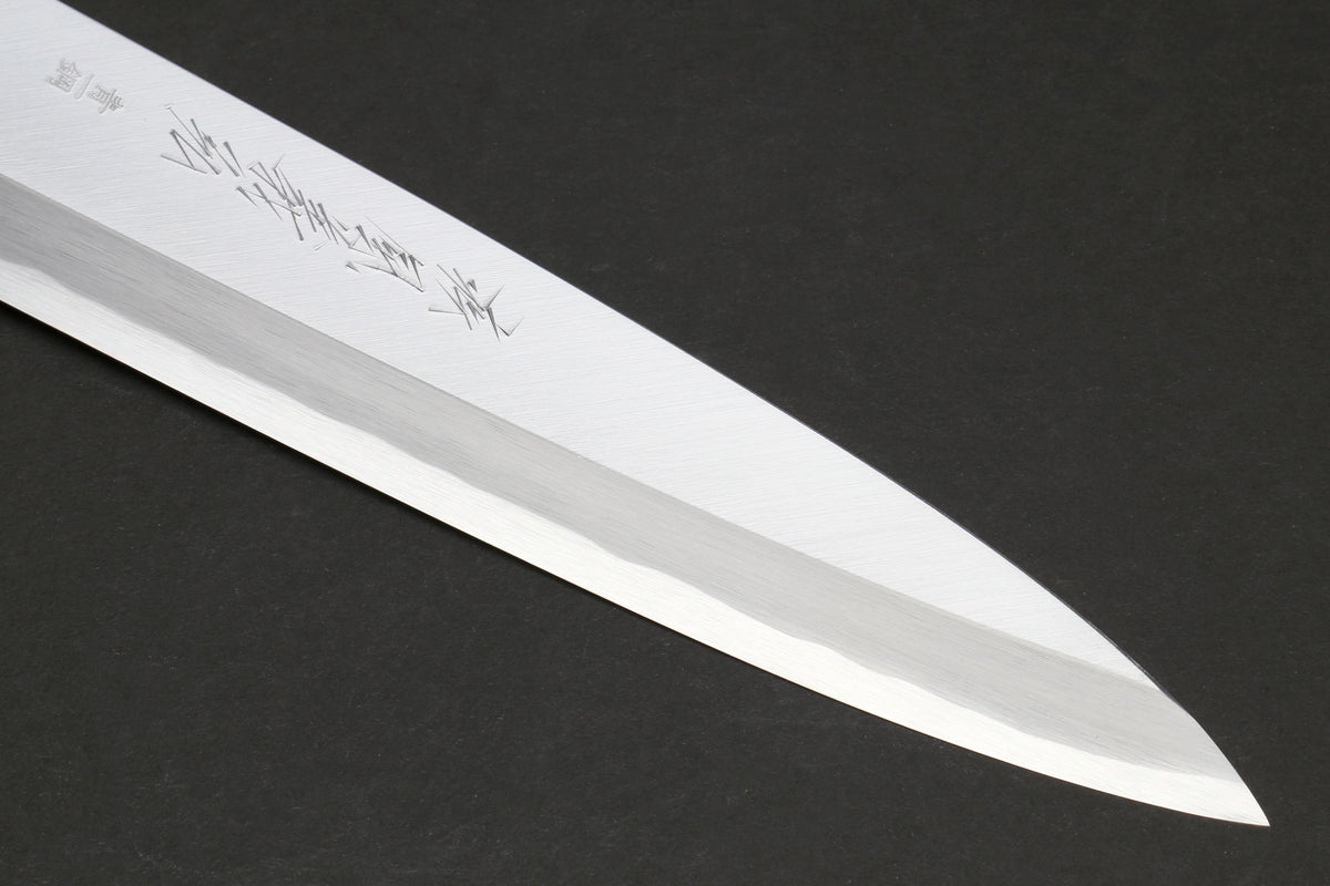 Japanese chef knife blade close-up with polished steel edge