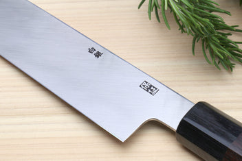 Single-edged vegetable knife with engraved blade and dark wooden handle