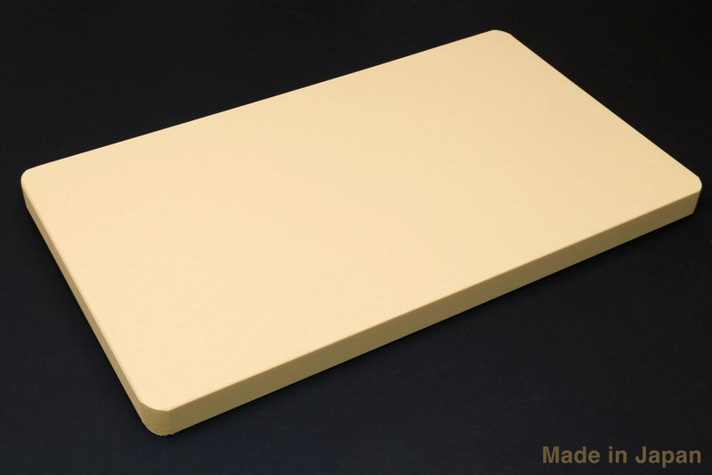 Soft cutting board with beveled corners, light cream color, flat top view