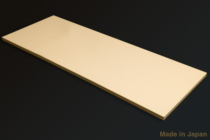 Cream cutting board laid flat lengthwise, smooth surface and straight beveled edges
