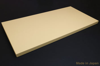 Beige Japanese cutting board, rectangular with beveled edges and smooth surface.