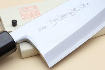 Deba chef knife blade close-up with etched marks and light wood handle