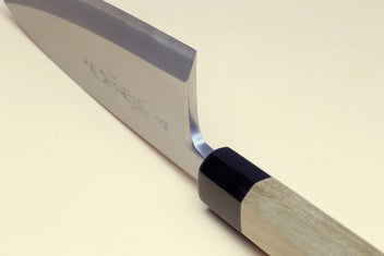 Deba chef knife bolster and edge detail with white blade and dark handle