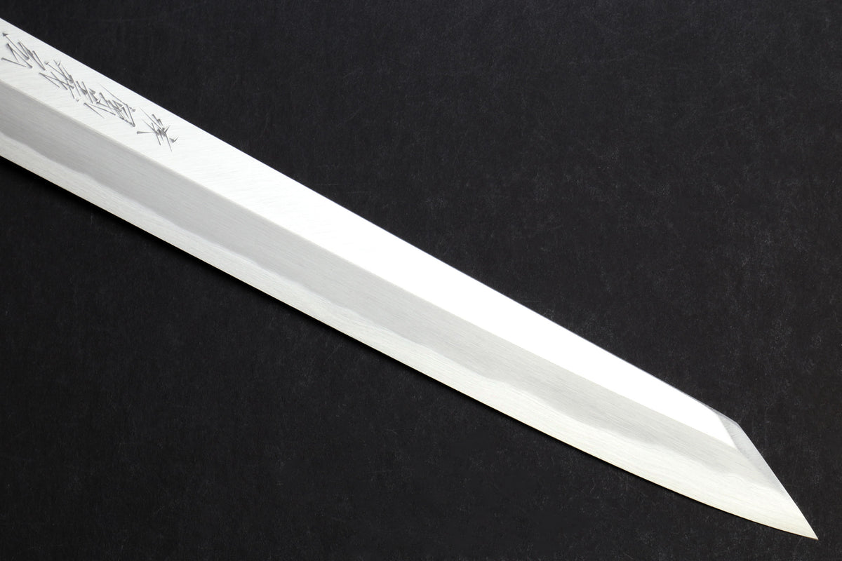 Japanese yanagi knife blade with decorative etching along the flat