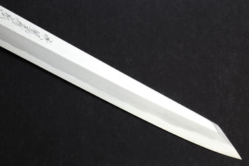 Japanese yanagi knife blade with decorative etching along the flat