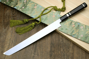 Japanese sashimi knife with long silver blade and black handle with checkered accents