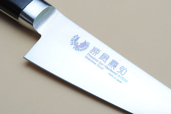 Poultry boning knife blade close-up with stamped mark and stainless steel edge