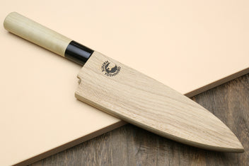 Deba fish fillet knife with white blade, light magnolia handle, and black ferrule