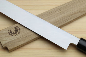 Yanagi sushi knife with white blade and rosewood handle in focus