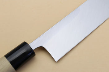 Silver blade section with pointed tip and black bolster on light wood handle