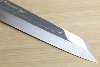 Japanese kitchen knife blade close-up with wavy hamon pattern