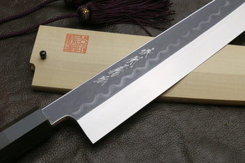 Kiritsuke knife on light saya with wavy blade finish and engraved kanji