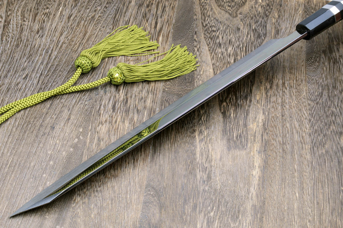 Mirror-finished Japanese knife with dark handle, green cord, and black cloth wrap